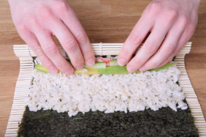 Rolling sushi maki with hands